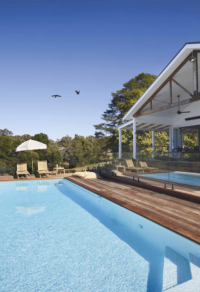 **Pool & deck** A large pool is happily oriented to catch all-day sun. "We used jarrah for the deck, which will weather and grey off," says Kerrie. She scored the sun lounges on eBay, while the umbrella is from Sunday Supply Co and the large raffia cushions are from Gypsy River.