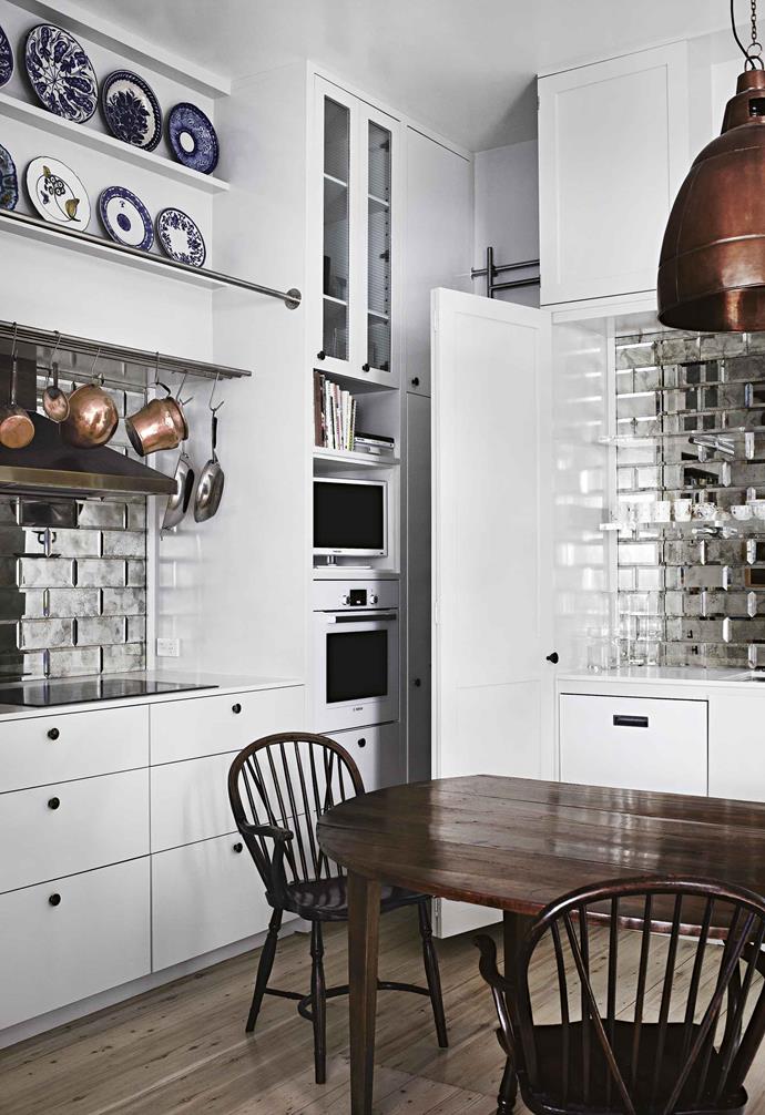 **Mirror tile splashback**<br><br>Subway tiles are the look *du jour* in kitchens, bathrooms and laundries, and the use of a mirrored tile takes this look to the next level. <br><br>Going with tiles also marks a departure from a single mirror as a [splashback](https://www.homestolove.com.au/kitchen-splashback-ideas-17258|target="_blank"), and adds a more eye-catching detail. <br><br>This space incorporates mirrored tiles with bevelled-edge options and a smoky dapple. The slight dark tinge ensures that any splashes won't be too visible, as opposed to a pristine mirror where every errant drop is glaringly obvious.<br><br>