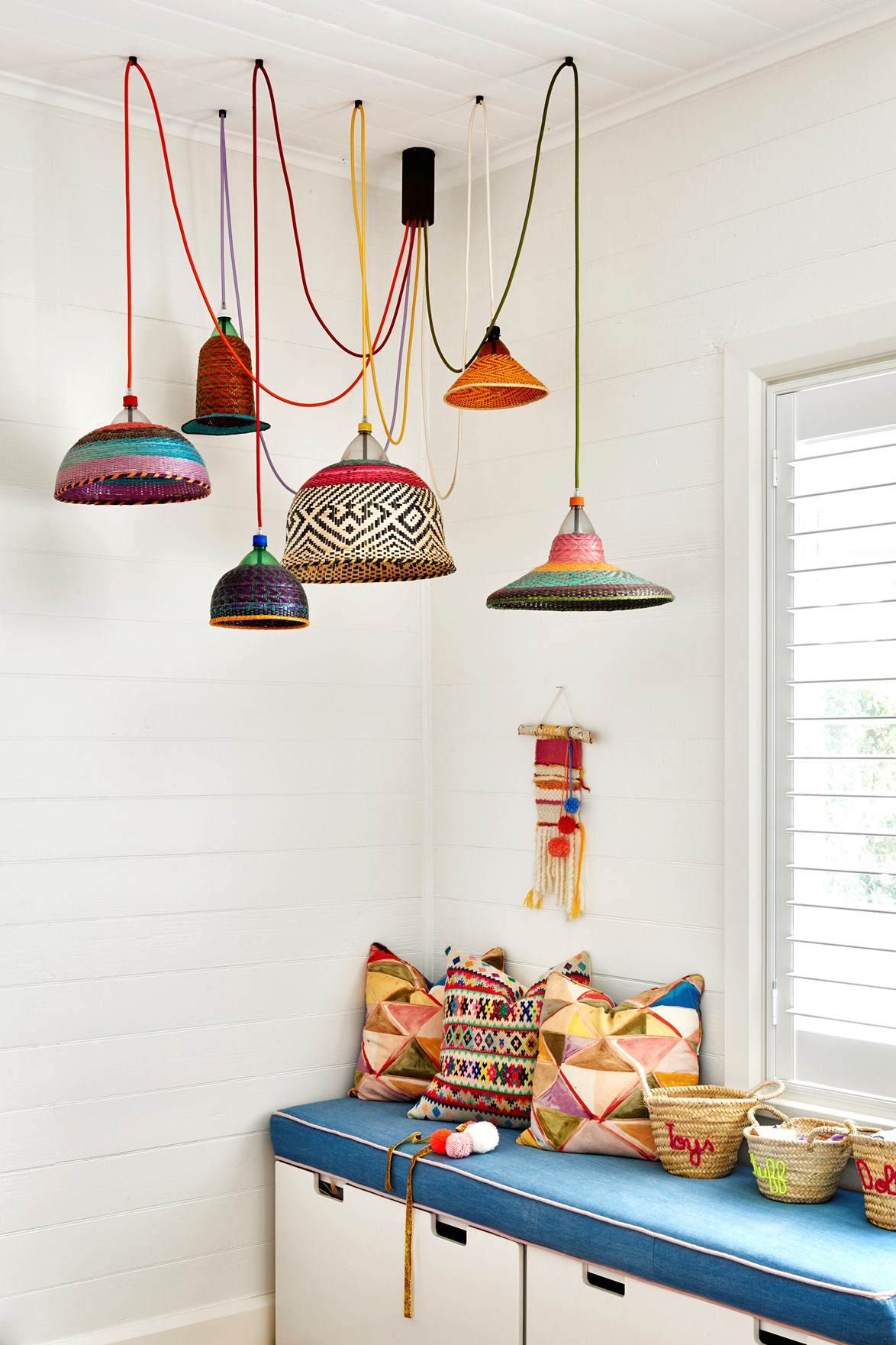 A window seat needn't be built-in cabinetry. This Ikea storage unit has been topped with a brightly-coloured upholstered cushion made to fit beneath the window of [this colourful Byron Bay cottage](https://www.homestolove.com.au/coastal-cottage-byron-bay-20442|target="_blank"), giving the flexibility to change up this spot as the needs change for the children who live here.