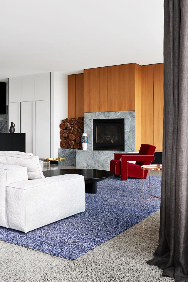 The timber feature wall around the fireplace adds warmth to this [living room](https://www.homestolove.com.au/fiona-lynch-williamstown-residence-house-tour-5109|target="_blank") conceived by Fiona Lynch.