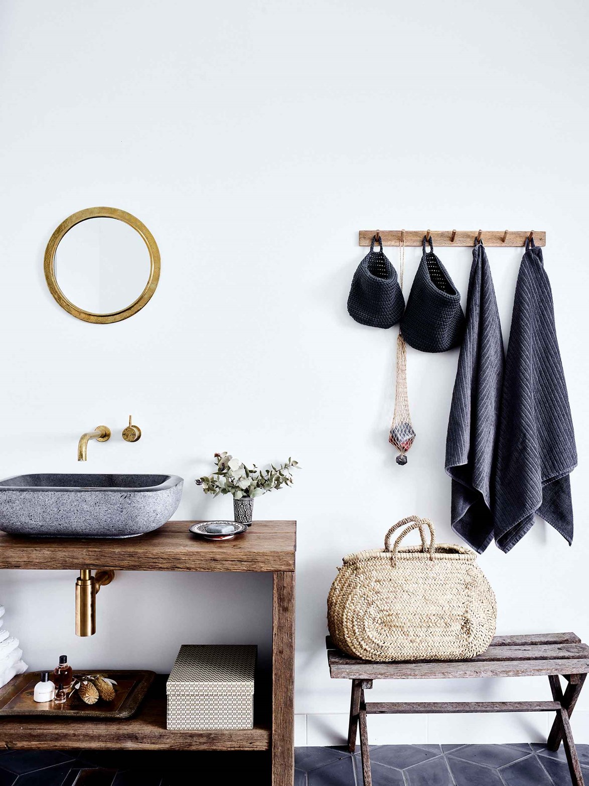 A custom-made recycled timber vanity paired with a concrete sink and brass tapware gives the bathroom a rustic minimalist aesthetic to tie in with the rest of this [Danish-inspired cabin](https://www.homestolove.com.au/small-modern-cabin-20503|target="_blank").