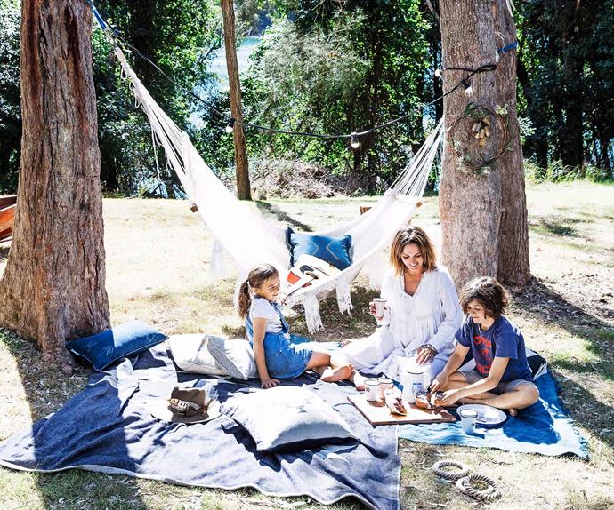 Family picnic outdoors with hammock in the background