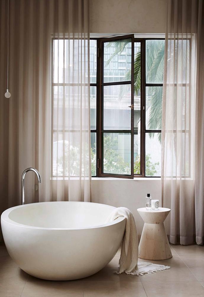 **Bathroom bliss** Elegant and durable, steel windows acquire character as they age. In this space they are softened by pale, sheer curtains.