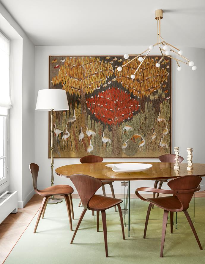 A nature-inspired palette has been used in the dining room of this reinvented Parisian apartment by Jacques Hervouet and architect Odile Burnod. The 1950s tapestry is attributed to Ateliers Pinton.