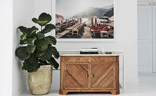 Photographic art hanging above a timber sideboard