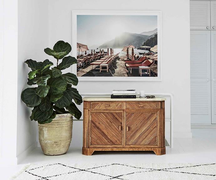 Photographic art hanging above a timber sideboard