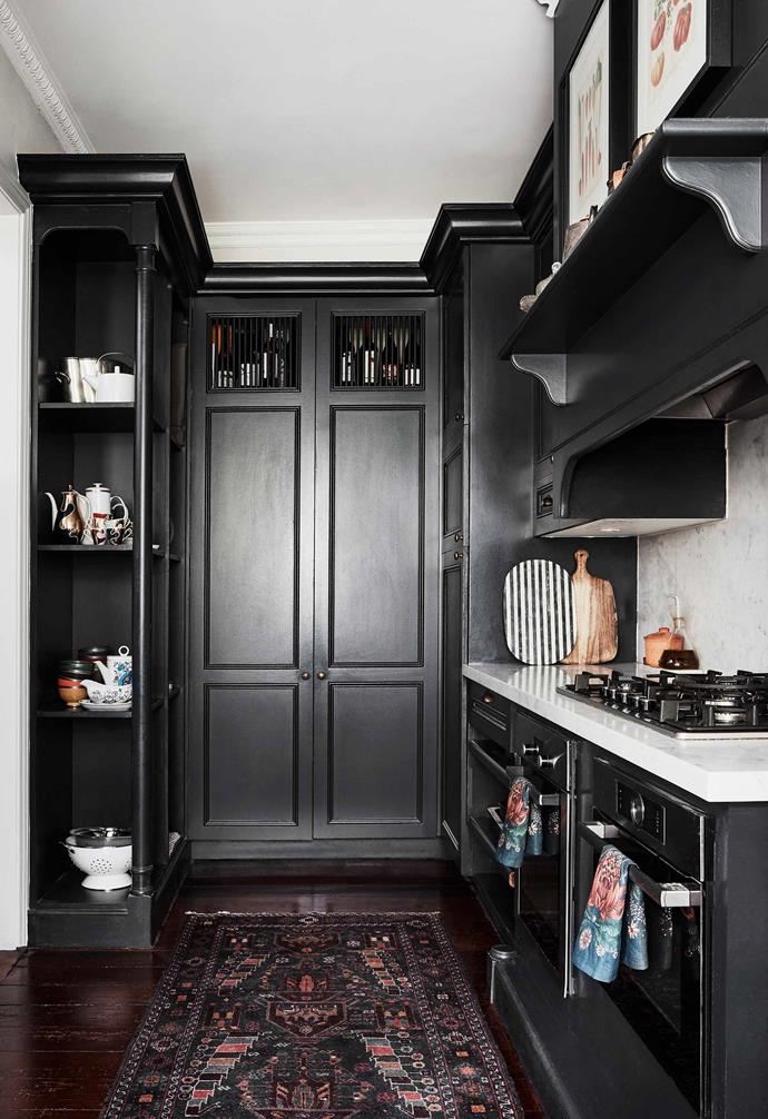 The sophisticated black cabinetry in the kitchen of this renovated [Italianate Victorian home](https://www.homestolove.com.au/italianate-victorian-home-19959|target="_blank") reach from the ceiling to the floor to provide as much storage space as possible.