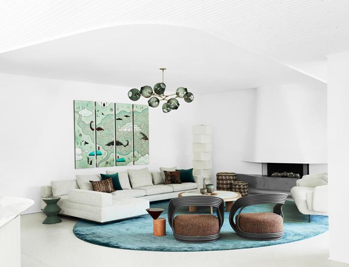 Minotti 'Freeman' sofa from De De Ce, Bonacina 'Eva' cane chairs in a lacquered finish, Christophe Delcourt 'Hug' sofa upholstered in Pierre Frey 'Candice' in Coquillage, a Cassina 'Rio' coffee table in oak with a marble inset and Nichetto 'Laurel' side table from Spence & Lyda, all on a custom oval cashmere rug from Cadrys. Lindsey Adelman 'Branching Bubble' chandelier. Isamu Noguchi 'UF4-L10' floor lamp. Artwork by Guan Wei from Martin Browne Contemporary.