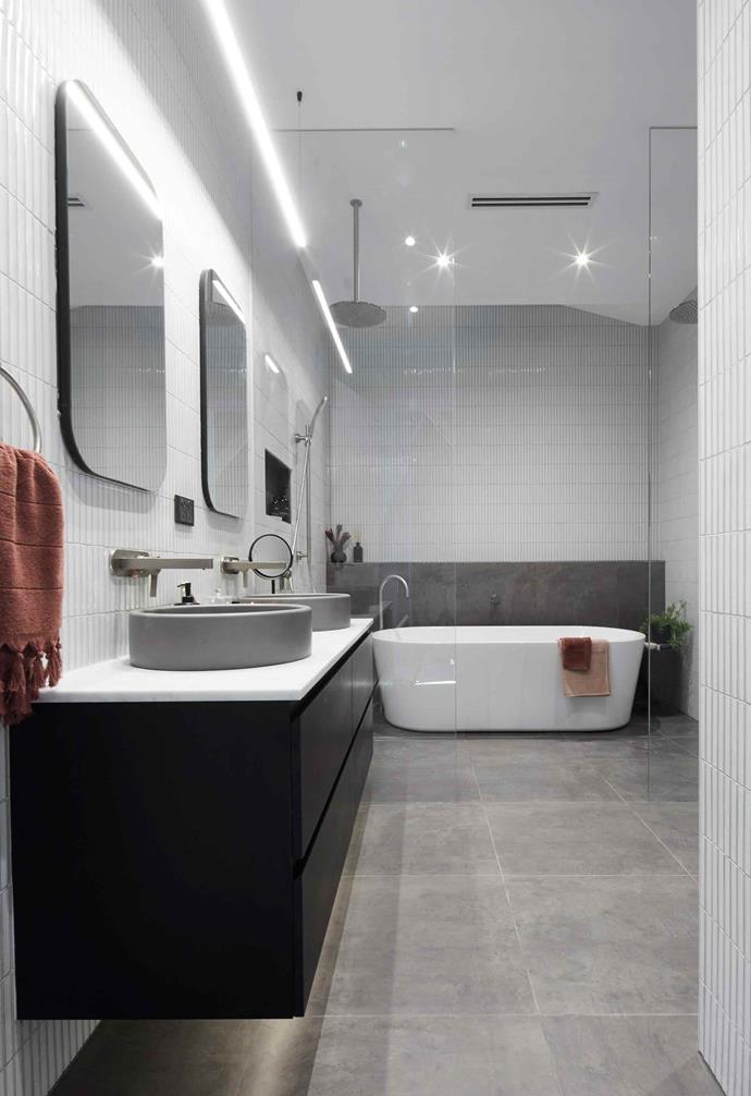 **Week 4, Main Bathroom** Tess and Luke took out the win in [Main Bathroom week](https://www.homestolove.com.au/the-block-2019-main-bathroom-reveals-20604|target="_blank") for their monochromatic space. Vertically laid slim-line subway tiles were paired with concrete basins, adding textural contrast to the space, and twin shower heads added to the luxurious design in the space.