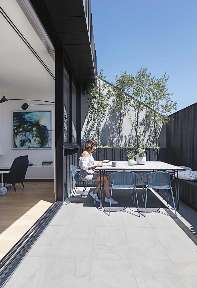 The couple started hunting for a more family-friendly home, even looking in more suburban areas where they could also have a garden. But they realised they would miss the buzz of the North Melbourne neighbourhood they had called home for so long.<br><Br>**Terrace** The living area opens to a sun-filled zone with a custom table designed by [Peachy Green](http://www.peachygreen.com.au/|target="_blank"|rel="nofollow") landscapers and 'Volley' chairs and rocker from [Tait](https://madebytait.com.au/|target="_blank"|rel="nofollow").  Planter and vase, [Mr Kitly](https://mrkitly.com.au/|target="_blank"|rel="nofollow").