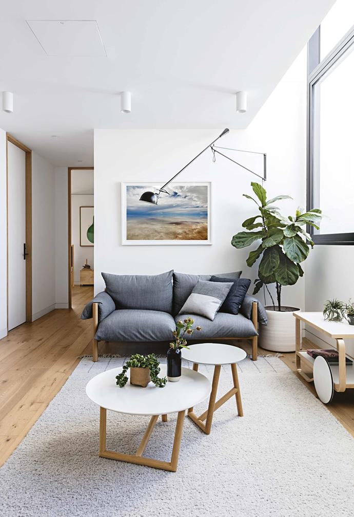**What were your aims with the interior?** <br><br>I like a calm, uncluttered space with clean lines. I'm surrounded by colour at work but at home I'm Dulux Lexicon Quarter all the way. I love black and white with timber. I'm glad we went with a warmer American oak veneer for our joinery rather than the paler timbers.<br><br>**Library** This room is brought to life with vivid greenery and artwork. The 'Wilfred' sofa from [Jardan](https://www.jardan.com.au/|target="_blank"|rel="nofollow"), Moroso 'Klara' tables from [Hub Furniture](http://www.hubfurniture.com.au/|target="_blank"|rel="nofollow") and an Artek '901' tea trolley from Luke Furniture add a fun, modern edge. The Flos '265' wall light is from [Euroluce](https://euroluce.com.au/|target="_blank"|rel="nofollow"). *Uyuni 1* by [Michelle Williams](https://www.michellewilliams.com.au/|target="_blank"|rel="nofollow"). Cushions, [Black Thread](https://www.blackthread.com.au/|target="_blank"|rel="nofollow").