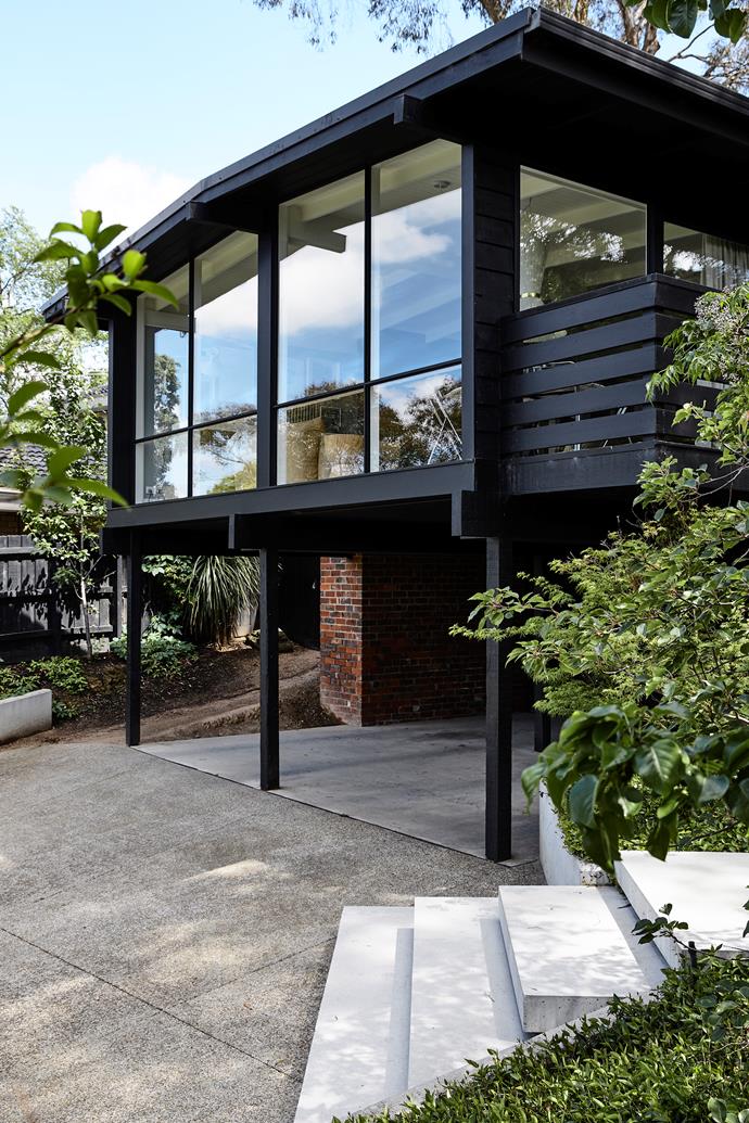 An exposed concrete driveway leads the way to this stunning home, which has been painted in Haymes 'True Black'. "The aggregate had coldstream stone, which has really nice tones," says Simone.