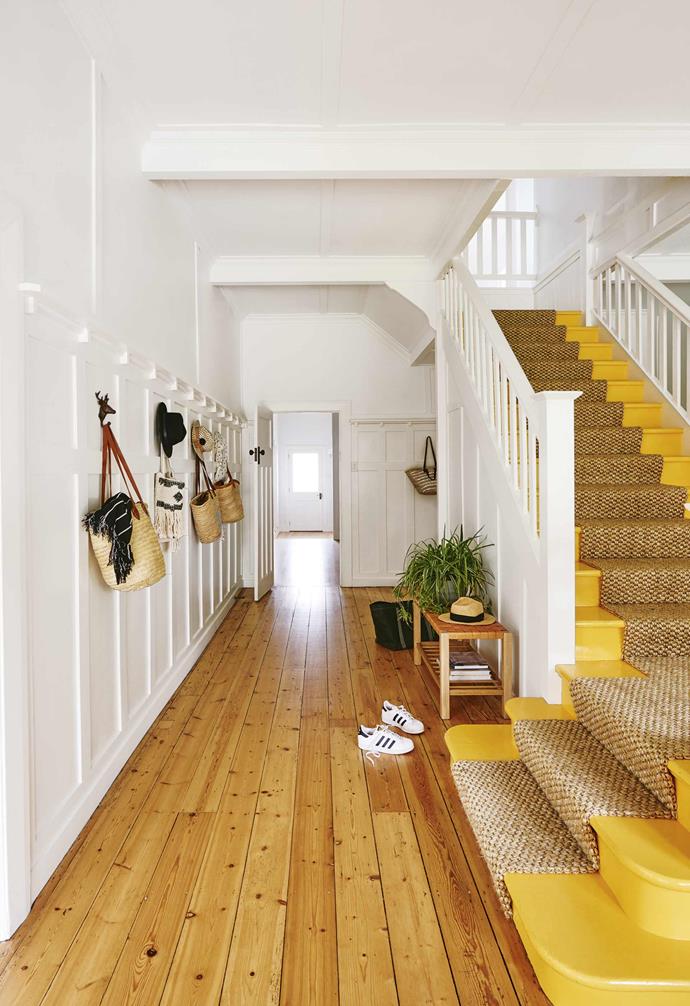Keeping it simple and functional, the entry hallway of this [renovated Californian bungalow](https://www.homestolove.com.au/californian-bungalow-barwon-heads-17909|target="_blank") is lined with statement wall hooks for storage, as well as a bench for storage and seating. 