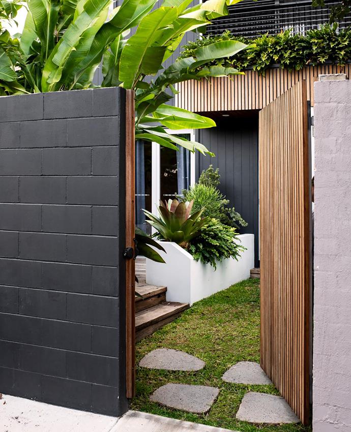 The entry from the rear lane into the garden features Barbosa lava stone stepping stones from Gather Co.