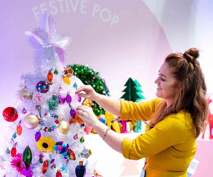 Gemma uses a combination of tinsel and large decorations - such as colourful gerberas - to fill out a [white Christmas tree from Spotlight](https://fave.co/36UAofv|target="_blank"|rel="nofollow").