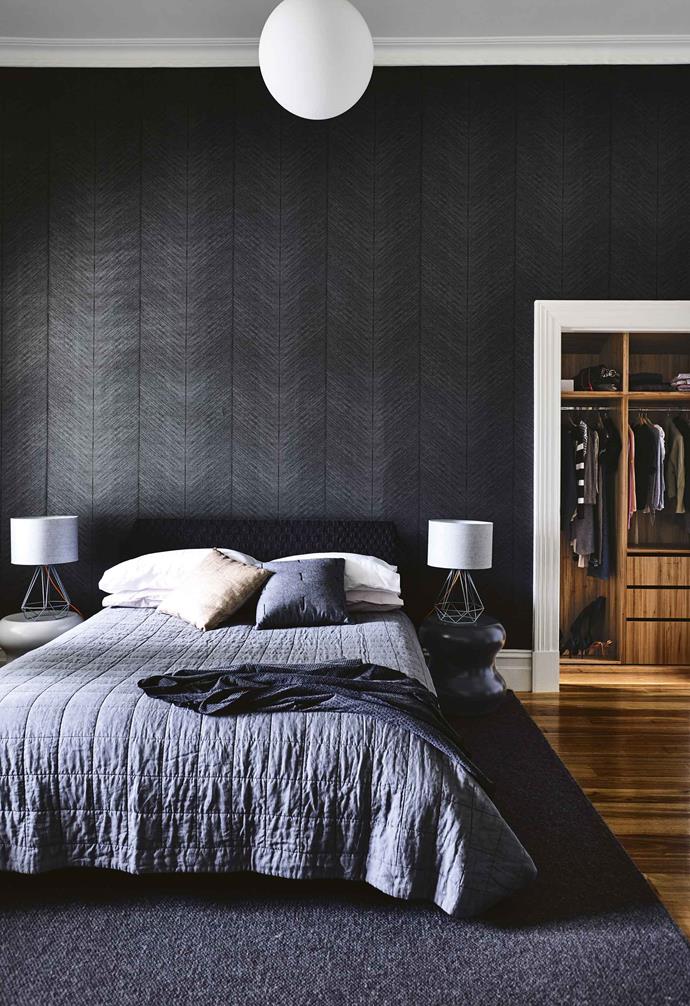 Dark feature walls don't have to just be on flat surfaces either. In the master bedroom of this [Melbourne family home](https://www.homestolove.com.au/timber-brick-house-melbourne-17933|target="_blank") a striking textural wallpaper was installed to create a moody look and feel.  