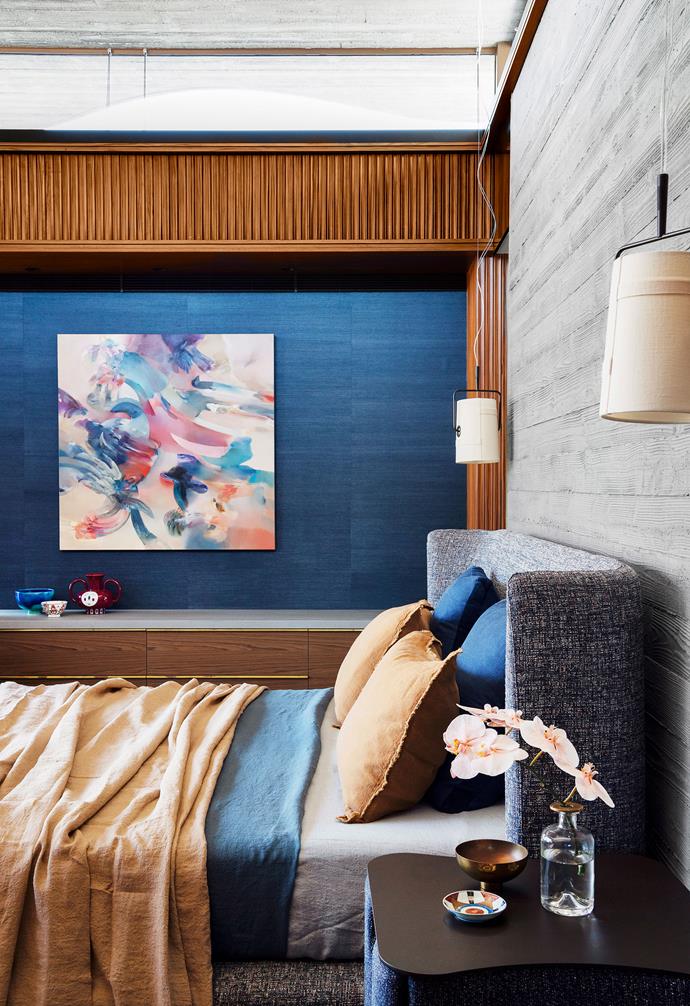 Seeking to add contrast to the predominantly concrete and timber palette in this [modernist home](https://www.homestolove.com.au/a-concrete-house-with-modernist-lines-19654|target="_blank"), a Classic Blue feature wall was added into this cosy nook in the master bedroom. 