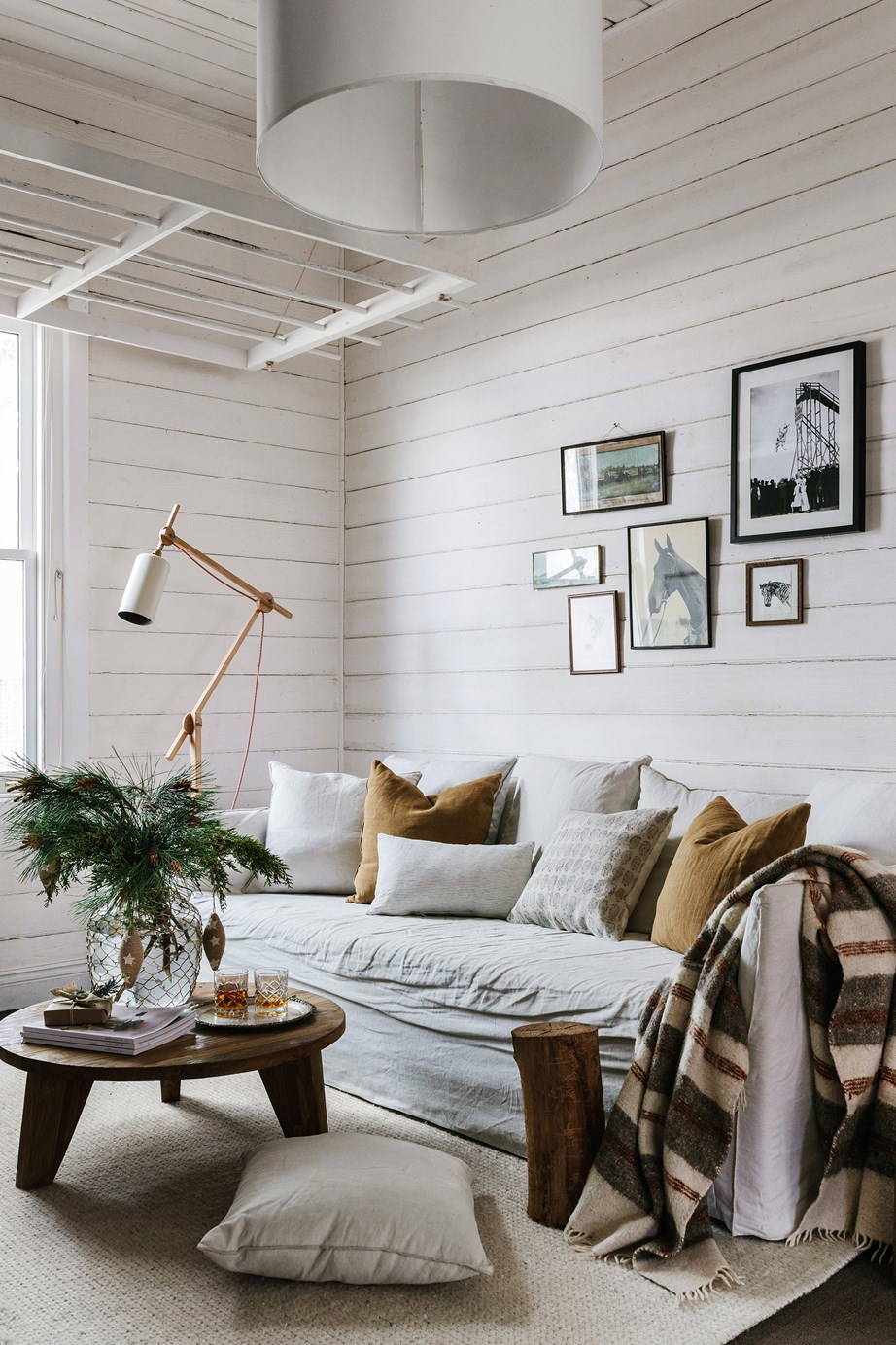 In photographer [Marnie Hawson's charming cottage in Central Victoria](https://www.homestolove.com.au/photographer-marnie-hawson-cottage-victoria-20958|target="_blank"), heritage details remind you of the home's past, while modern furniture makes it feel fresh and comfortable. Beneath an original clothes hanger is a MCM House sofa, coffee table and cushions from Trentham General, and an Armadillo & Co rug.