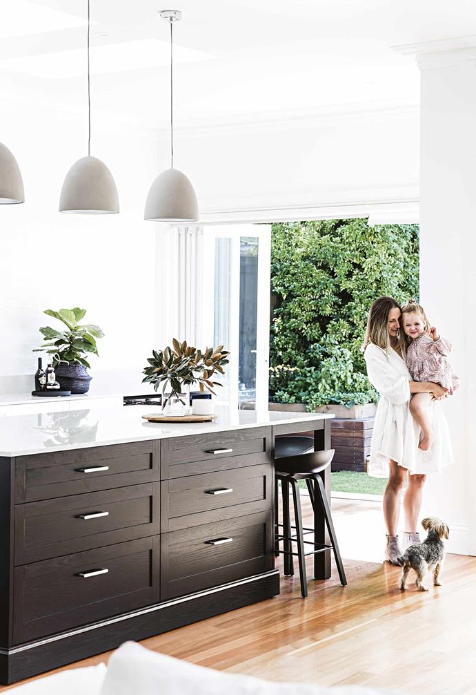 "When we moved in, I thought we would only sand and [repolish the floors](https://www.homestolove.com.au/how-to-clean-and-care-for-timber-flooring-1662|target="_blank") and paint the skirting boards. But as soon as we painted the skirting boards, the walls looked green, so we painted those as well," says Jennie.<br><br>**Kitchen** Owner Jennie (pictured with daughter, Amelie and Charlie the dog) has created a family-friendly cooking zone with a generous island bench where the cabinetry has been finished in Black Japan stain. Cheeseboard, [Papaya](https://www.papaya.com.au/|target="_blank"|rel="nofollow"). Candle, [Cotton On](https://cottonon.com/|target="_blank"|rel="nofollow"). Marble coaster, [Pond](https://pond-pond.com/|target="_blank"|rel="nofollow"). Basket, [Olli Ella](https://au.olliella.com/|target="_blank"|rel="nofollow"). Pendant lights, [Fanuli](https://www.fanuli.com.au/|target="_blank"|rel="nofollow").
