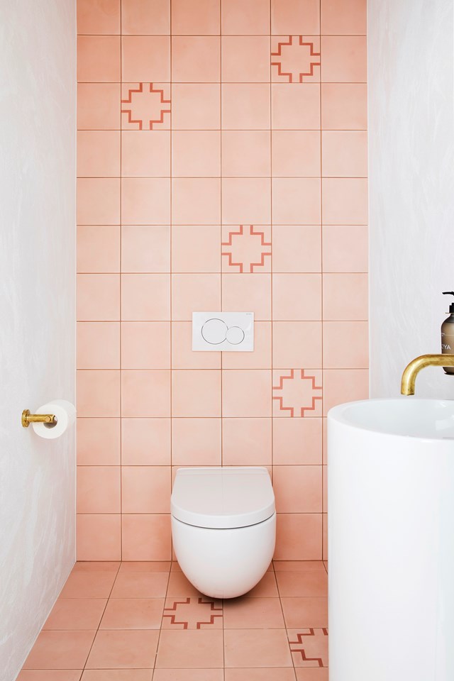 Embrace the current fixation with [millennial pink](https://www.homestolove.com.au/millennial-pink-bathrooms-18963|target="_blank") and up the sophistication stakes with sleek gold tapware and a tiled feature wall. You can also get a similar look using waterproof, removable wallpaper.