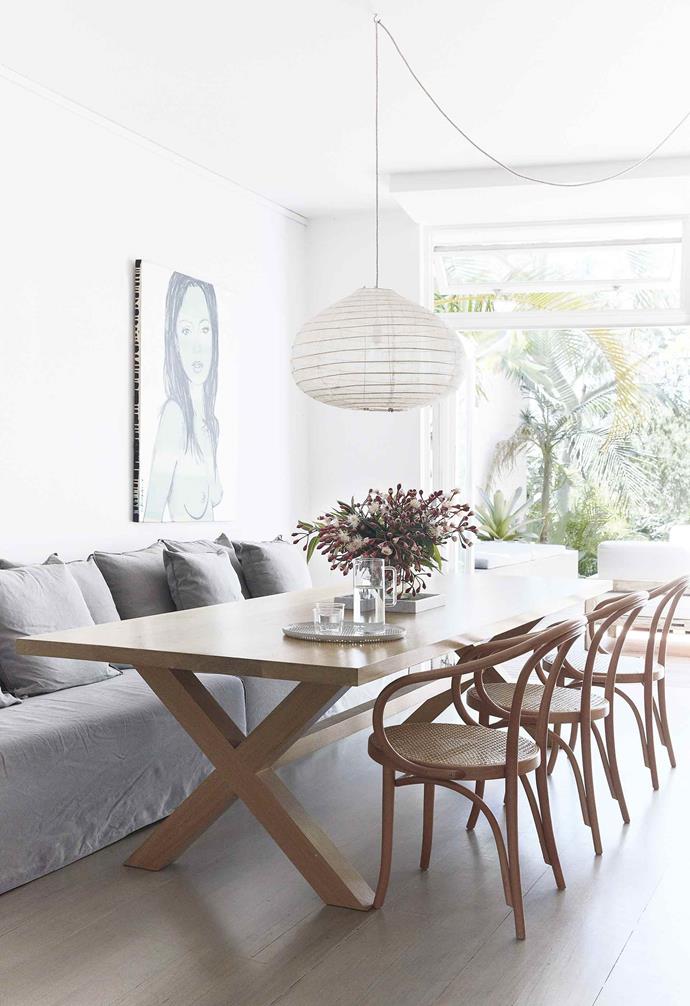 In the open-plan dining and kitchen room of this [Bondi duplex](https://www.homestolove.com.au/duplex-home-renovation-19533|target="_blank"), the casual dining space features a 3 metre oak dining table from [The Wood Room](https://thewoodroom.com.au/|target="_blank"|rel="nofollow") that's paired with a set of Le Corbusier dining chairs on one side, and a relaxed sofa from [MCM House](https://www.mcmhouse.com/|target="_blank"|rel="nofollow") on the other. 