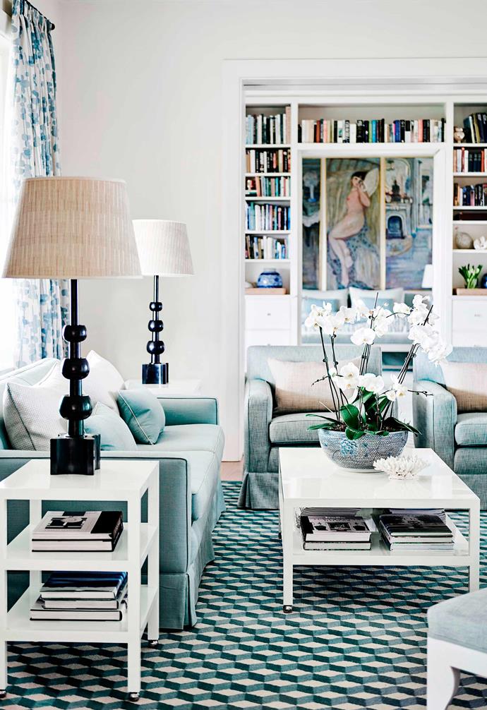 This [Hamptons-style clifftop beachhouse in Portsea](https://www.homestolove.com.au/clifftop-beach-house-hamptons-style-19414|target="_blank") was originally designed by Victorian designer John Coote and has since been lovingly updated by Adelaide Bragg & Co. Working with the original geometric carpets, the team echoed the coastal colour cues with white and pale blue furniture.