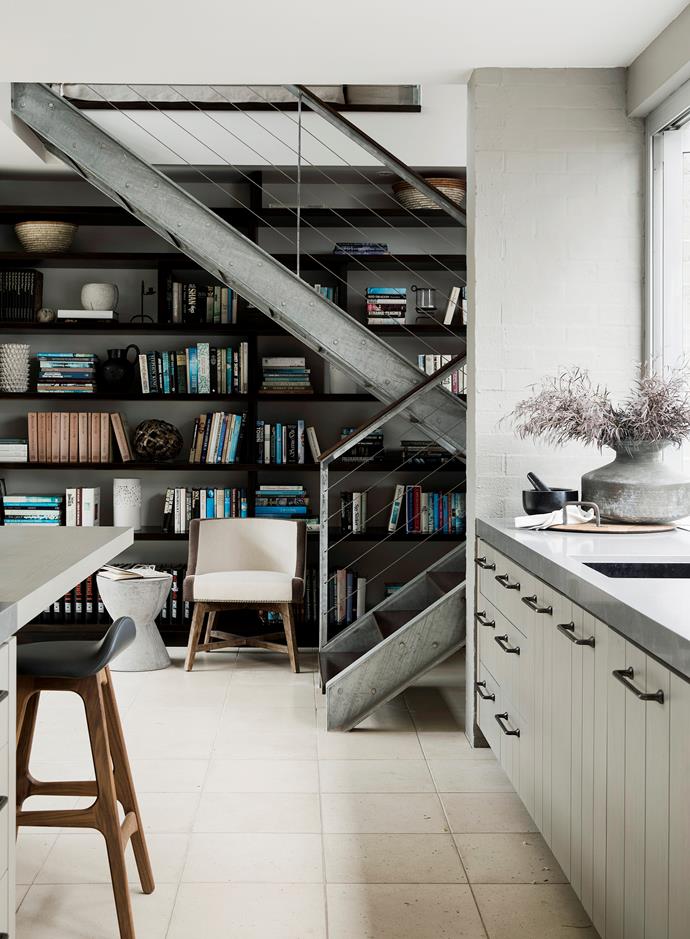 The existing steel stairs and shelves were integrated into the room by a seating area that creates a library feel.