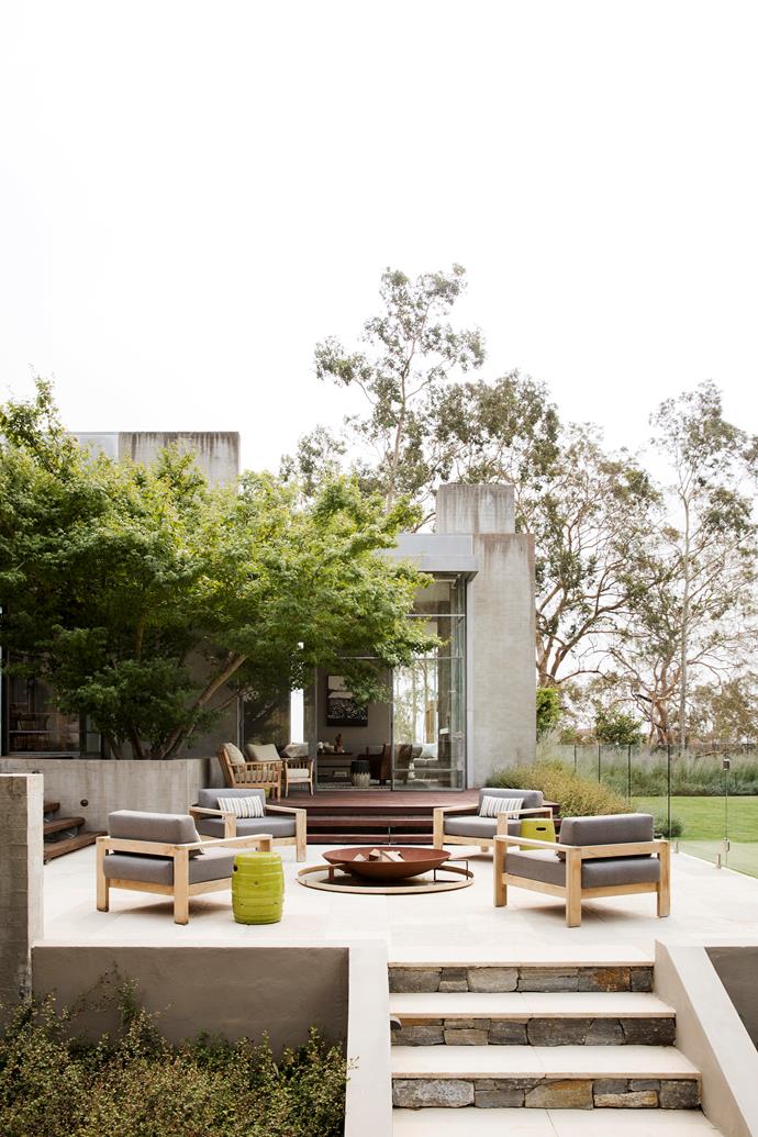 The Robert Plumb 'Angelina' firepit from Eco Outdoor sits adjacent to the main living room and kitchen. Milos armchairs, cushions and ceramic garden stools, Weylandts.
