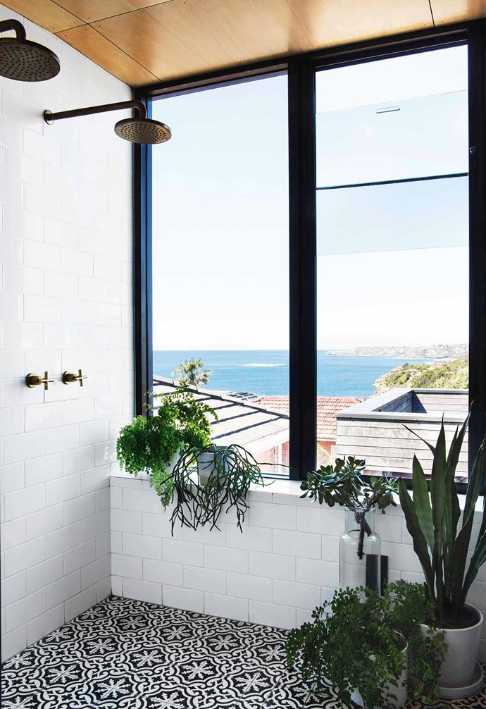 Patterned black and white tiles add a playful touch to the shower zone in this [reverse brick veneer home](https://www.homestolove.com.au/reverse-brick-veneer-house-18270|target="_blank"). White subway tiles line the walls and is contrasted with a plywood clad ceiling. 