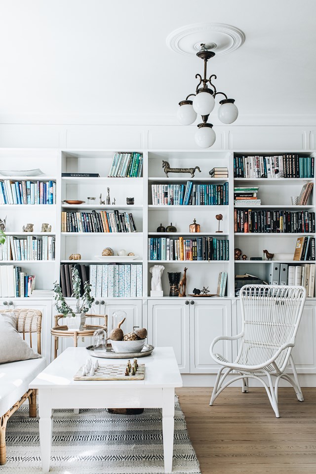 Arranging your books and home décor by colour might be a no-no for people who prefer an anywhere-it-fits route, but it does make shelves look less cluttered and creates a focal point.