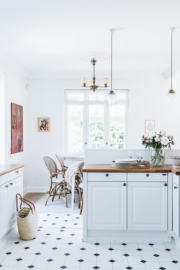 After moving into [a home she'd admired since childhood](https://www.homestolove.com.au/danish-interior-design-21159|target="_blank"), Louise Andreasen set to work updating the property's 'strange' and tired interior. "We've worked hard to bring it back to the old style," she says. This involved a total revamp of the kitchen, which was gutted and replaced entirely. The end result is a timeless white kitchen complete with oak benchtops.