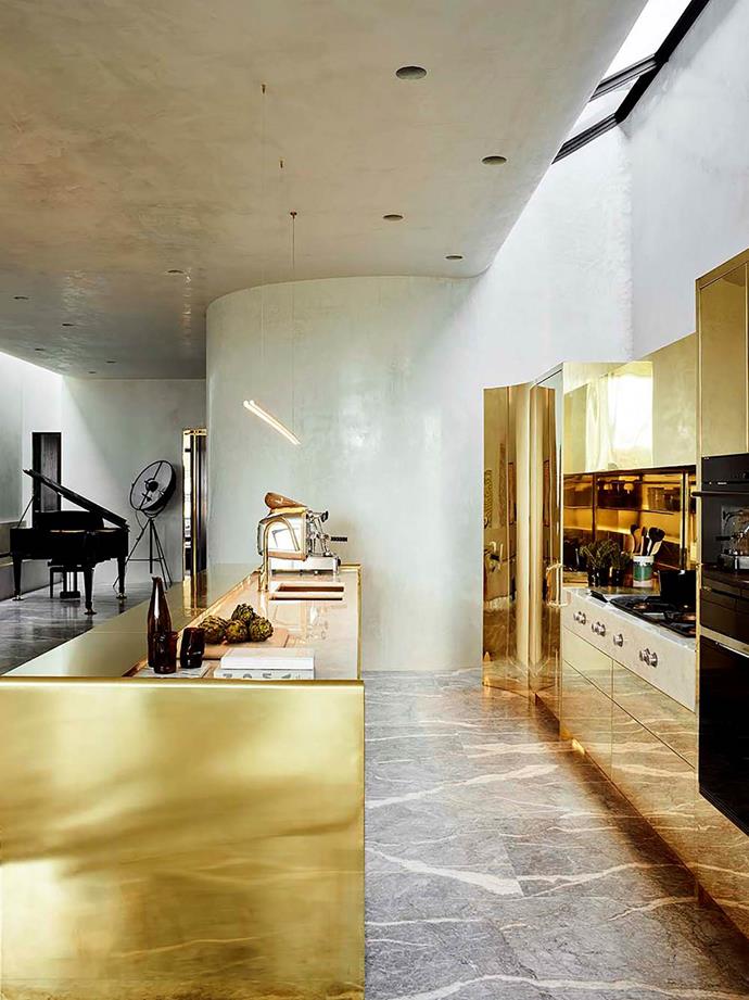 Architect Rob Mills transformed this former cardboard factory into a [luxurious family home](https://www.homestolove.com.au/luxurious-transformation-of-a-former-factory-in-melbourne-6171|target="_blank"). The striking polished brass island bench in the industrial-style kitchen makes a bold statement that is offset by grey-veined marble.