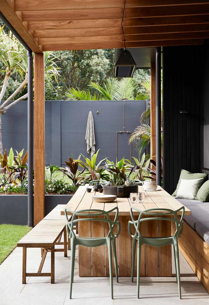 The alfresco zone of [Byron Bay's Barefoot Villa](https://www.homestolove.com.au/barefoot-bay-villa-byron-bay-21018|target="_blank") has been designed to complement its surrounds; a Robert Plumb timber dining setting along with four Sage Green by Philippe Starck chairs take centre stage. Just beyond the dining space, an outdoor shower by Mon Palmer sits, which gets plenty of use as guests retire from days at the beach.