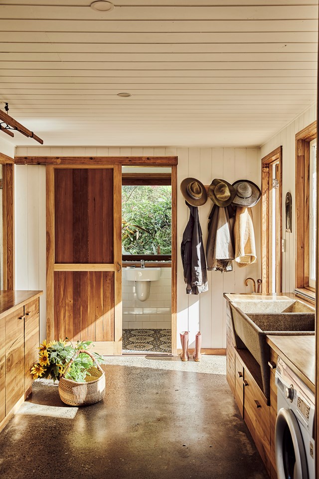 A reclaimed concrete trough features in the laundry of this family [home built from sustainable and recycled timbers](https://www.homestolove.com.au/recycled-timber-home-sustainable-21272|target="_blank") injecting a sense of vintage charm. Concrete floors make the space durable and easy to clean, while custom-made timber cabinetry provides plenty of storage.