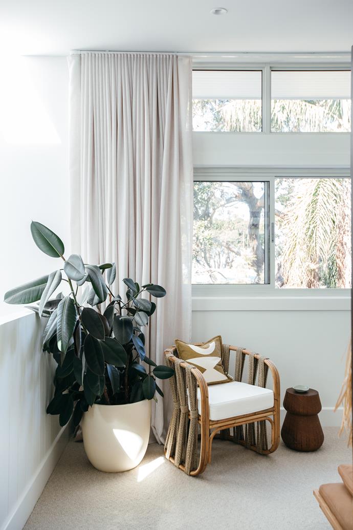 Floor-to-ceiling curtains create a hotel feel.