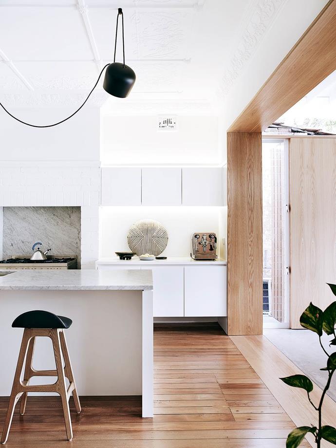 In this [modernised Sydney duplex](https://www.homestolove.com.au/duplex-home-renovation-2762|target="_blank"), a Flos Aim pendant light from Euroluce contrasts against the restrained palette in the kitchen, creating a statement while illuminating the island bench.