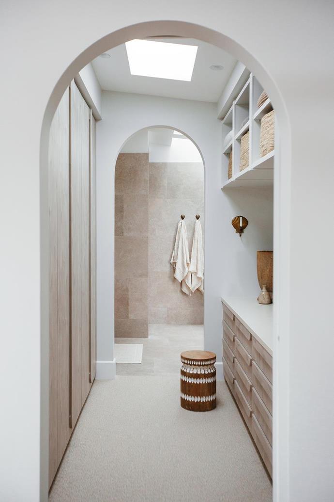 Archways are a continuing theme throughout the [Kyal and Kara's parent's retreat](https://www.homestolove.com.au/parents-retreat-kyal-and-kara-21352|target="_blank") so they incorporated them into their walk-in wardrobe design. Ploytec 'Angora Oak Woodmatt' joinery in the walk-in robe ties in beautifully with their coastal aesthetic.