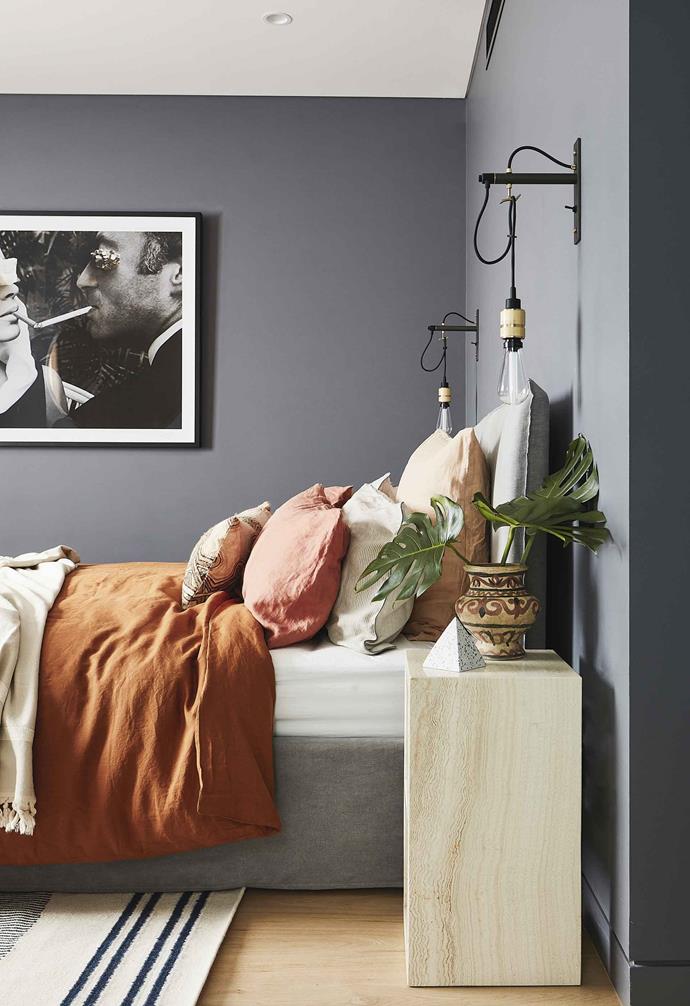 Grey walls and a crisp white ceiling create a cosy haven in the bedroom of this [Scandi-noir home](https://www.homestolove.com.au/scandi-noir-house-20344|target="_blank").