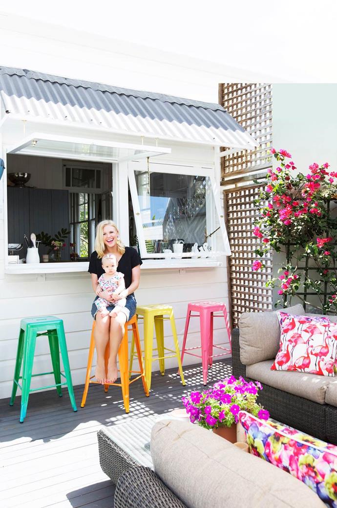 With servery windows opening out from the kitchen, the deck at this [Queenslander-style cottage](https://www.homestolove.com.au/queenslander-cottage-renovation-4061|target="_blank") has become a much-used space, full of colour. 