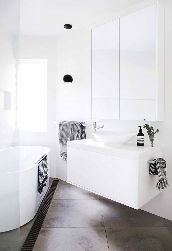 This family's well-laid plans, strict budget and minimalist palette has resulted in the dramatic makeover of a light-filled [Sydney apartment](https://www.homestolove.com.au/minimalist-apartment-northern-beaches-17911|target="_blank"). The couple managed to fit a lot into the small bathroom while keeping things simple to balance their budget.
