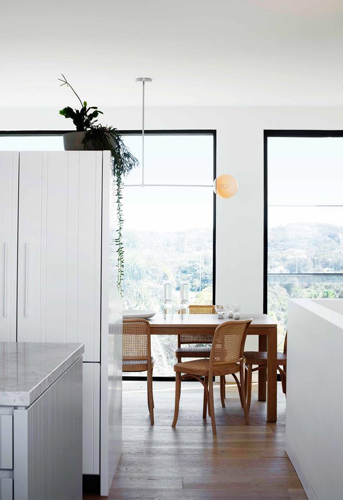 **Kitchen/dining** "The units don't reach the ceiling, so the kitchen and dining room stay connected," says Rosemarie. To maintain the flow, all the materials are tonally calm, with the polyurethane joinery in [Dulux](https://www.dulux.com.au/|target="_blank"|rel="nofollow") Milton Moon and the island bench topped with White Fantasy marble from [Artedomus](https://www.artedomus.com/|target="_blank"|rel="nofollow"). Caesarstone Snow features on the other benches. Secto wall lights, [Fred International](https://fredinternational.com.au/|target="_blank"|rel="nofollow"). American oak table and Hoffmann chairs, [The Wood Room](https://thewoodroom.com.au/|target="_blank"|rel="nofollow").