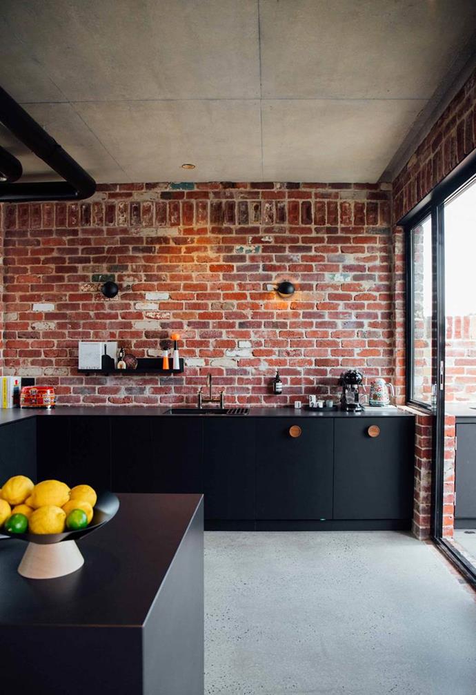 This [industrial-style new brick house in Perth](https://www.homestolove.com.au/brick-house-perth-19916|target="_blank") retains a contemporary vibe in the kitchen with sleek black joinery and steel-framed windows. Original brick walls feature in most rooms and form a natural splashback here.