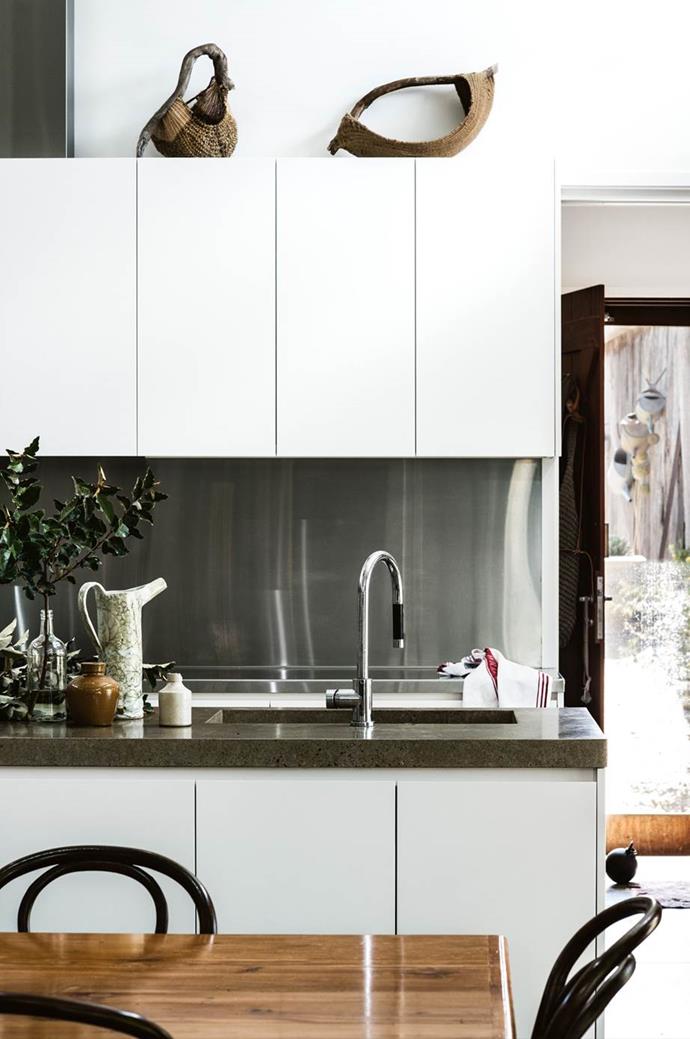 Stainless steel doesn't need to give off an industrial vibe. This simple finish gives a glossy, contemporary look to an all-white kitchen in [this converted cottage](https://www.homestolove.com.au/joining-separate-cottages-together-14045|target="_blank").