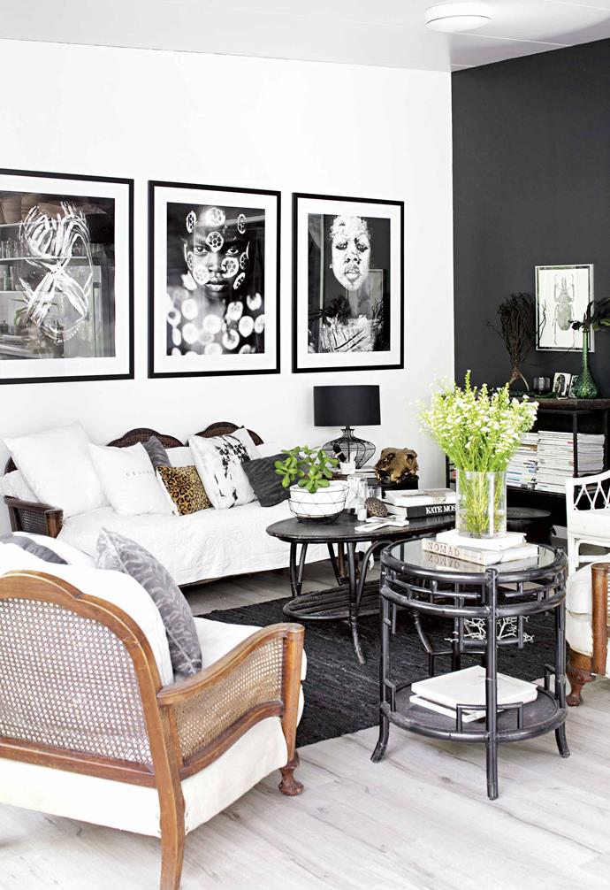 **Don't be afraid of the dark** The idea of [charcoal feature walls](https://www.homestolove.com.au/dark-wall-ideas-18639|target="_blank") may be confronting to some, but when done right they can add focus to a room, without making it dark. "The room felt so stark when it was all white," says Lara. "It's actually quite a big space that needed definition to make it a bit more cosy." The beloved [cane chairs](https://www.homestolove.com.au/15-best-rattan-chairs-13693|target="_blank") belonged to Lara's great-grandmother and are more than 100 years old. The framed portraits, by Mario Gerth, bring Lara's African upbringing to the forefront of the living area.<br><br>**Tip**: Bring in lush greenery, timber tones and a variety of textures to balance a [dark feature wall](https://www.homestolove.com.au/dark-wall-ideas-18639|target="_blank").
