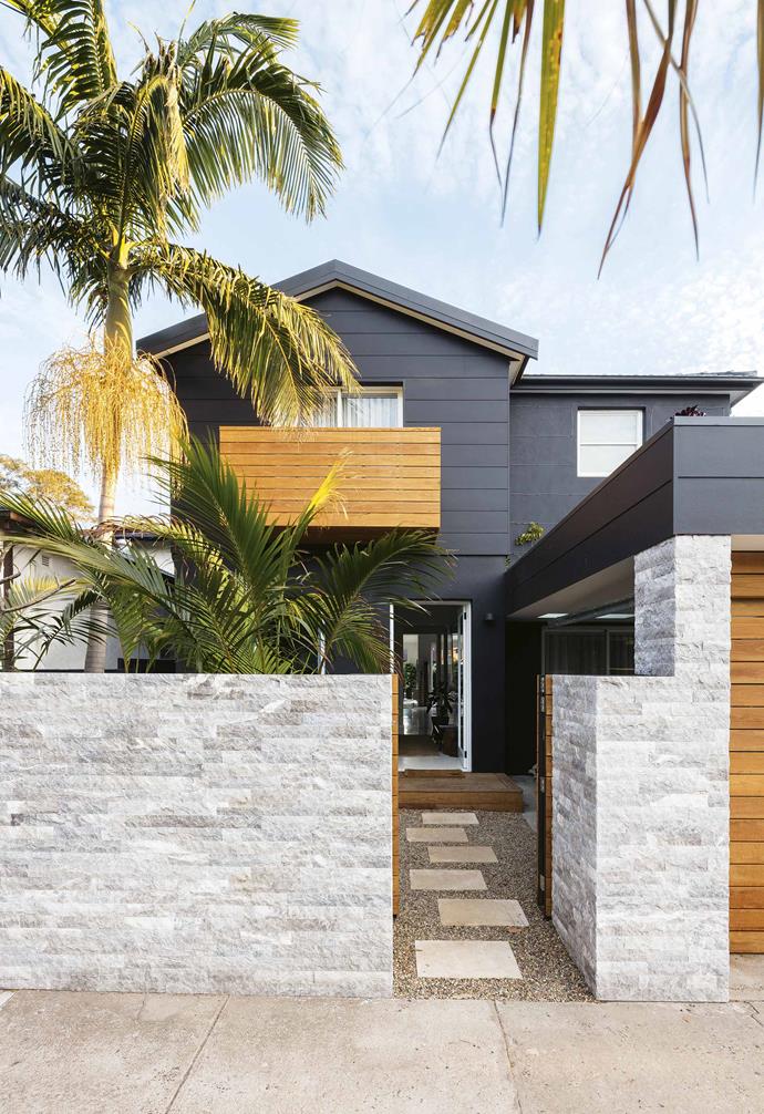 For a more dramatic style of fencing, opt for a stone wall. For the exterior fencing of this [tropical resort-stye home](https://www.homestolove.com.au/tropical-resort-style-home-18497|target="_blank"), marble cladding was chosen for the front fence, creating a dramatic contrast with the timber accents of the home's dark exterior.