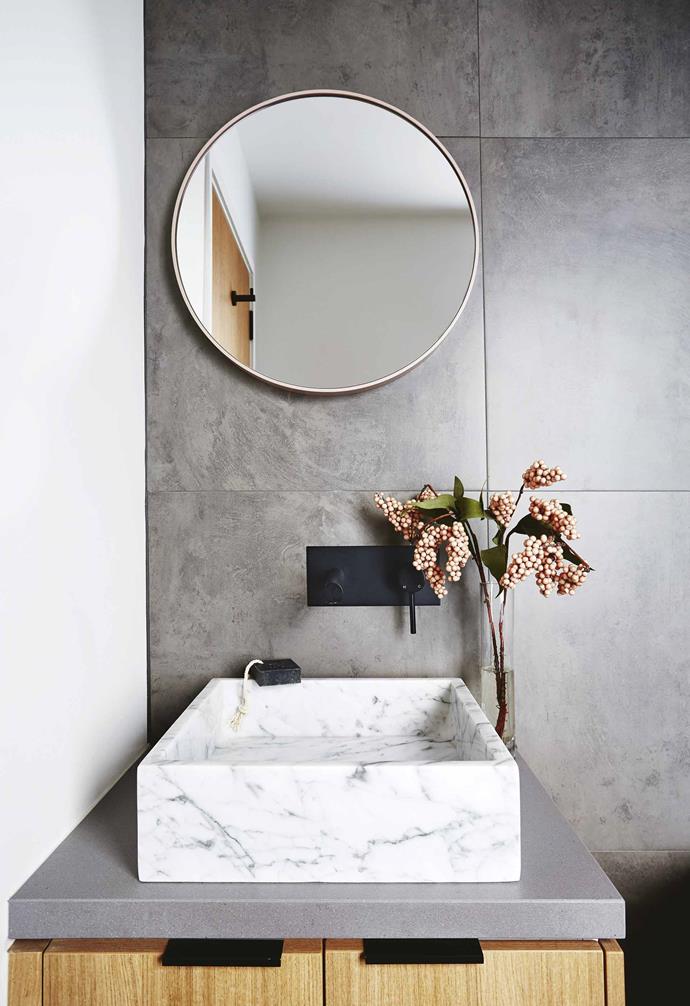 With all that extra space to fill, the couple set to work with enthusiasm on their fit-out. Limited by budget, they spent weeks researching fixtures and fittings.<br><br>**Bathroom** The elegant palette of white marble paired with grey and warm timber makes the bathroom a zen space.