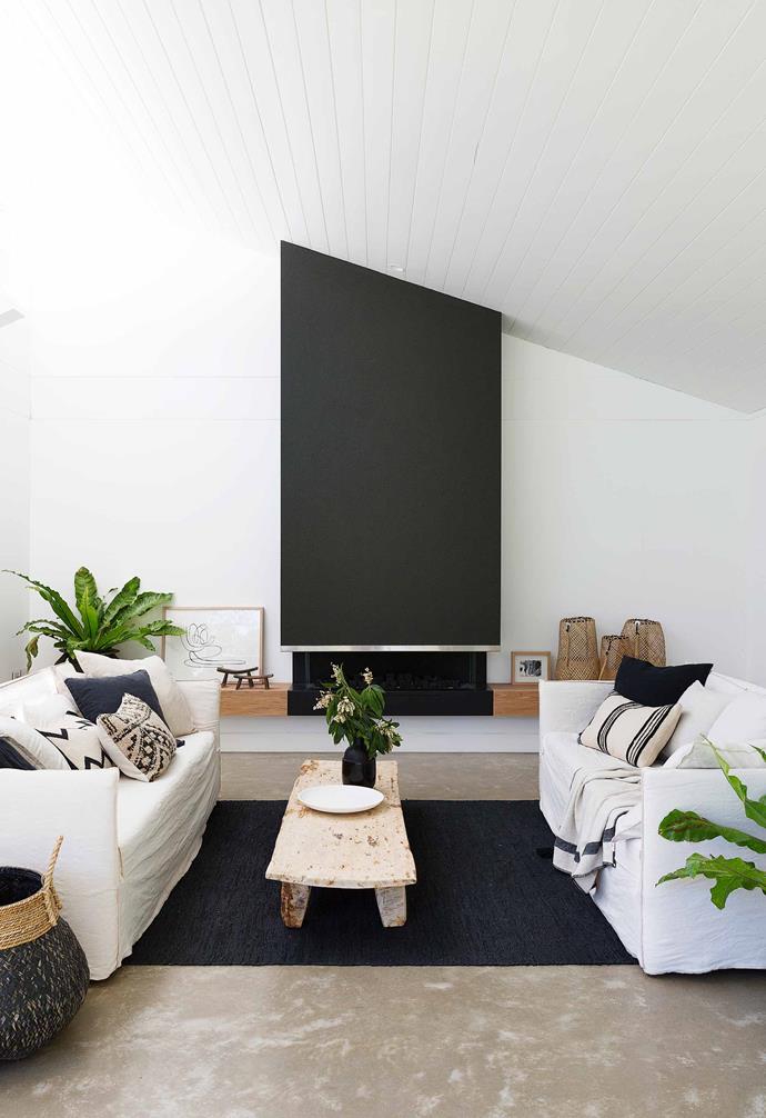 A well-placed basket in the living room of this [fibro cottage](https://www.homestolove.com.au/fibro-cottage-avalon-20548|target="_blank") is the perfect place to tuck excess throws and cushions when they're not needed.