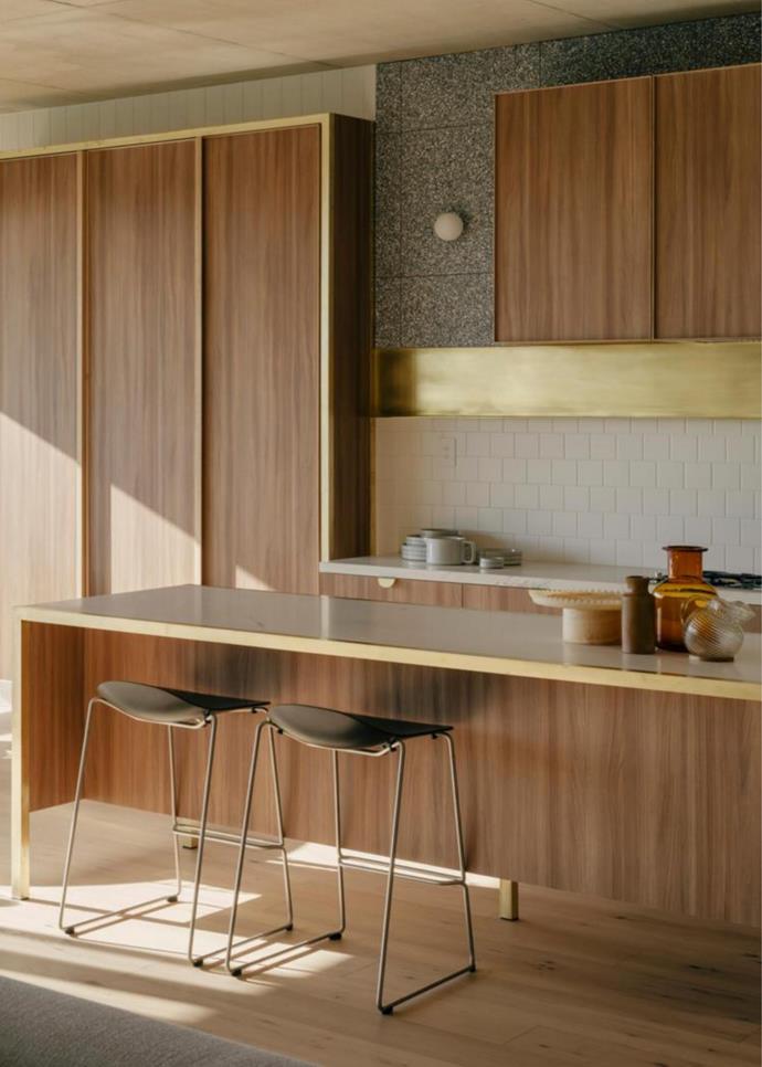 Design: Freadman White architects in collaboration with Milieu Property. In the kitchen, a sleek shelf and joinery pulls all in brass bring a gleam to the neutral interiors.