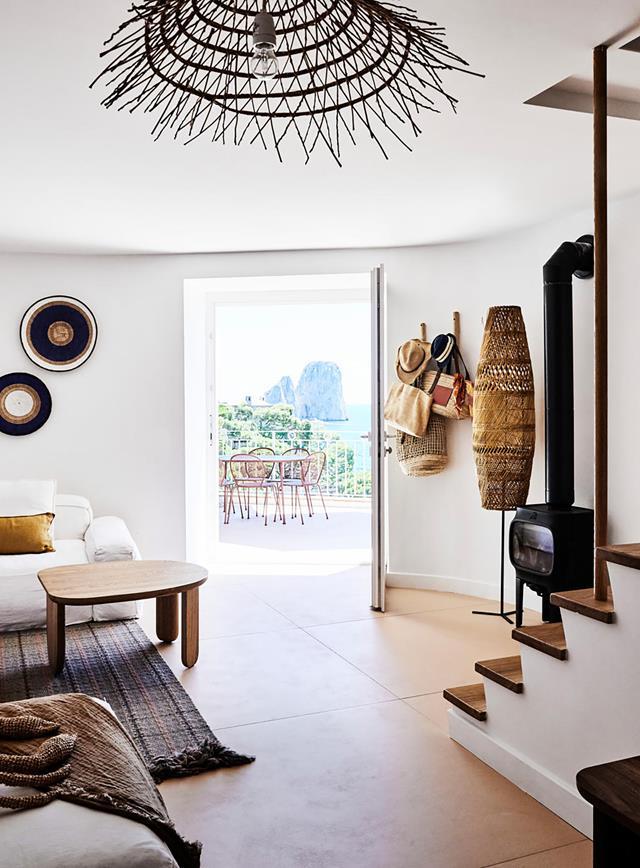 Exalted by an iconic coastal rock formation at its doorstep, this [Mediterranean villa](https://www.homestolove.com.au/amalfi-coast-holiday-home-21070|target="_blank")
 is an Australian family's idyllic summer escape. Tactile, handcrafted furnishings warmly embrace the living room's pared-back architectural details.