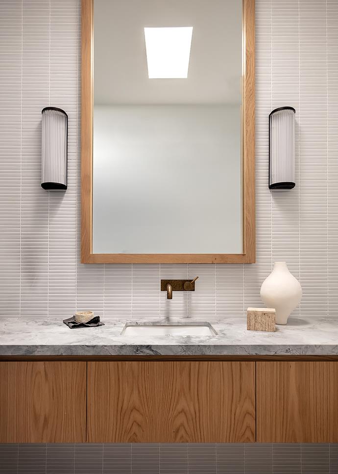 The powder room features Super White Dolomite stone on the vanity. Ceramics by Katarina Wells from Curatorial and Co and Alana Wilson Studio. All tapware in the house is from Astra Walker and has an eco-brass finish.